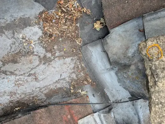 Leaf debris and silt built up in a lead roof valley that was letting water into a Newcastle home