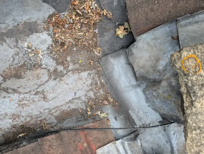 Before: lead roof valley choked with leaves and silt causing a leak into a Newcastle home