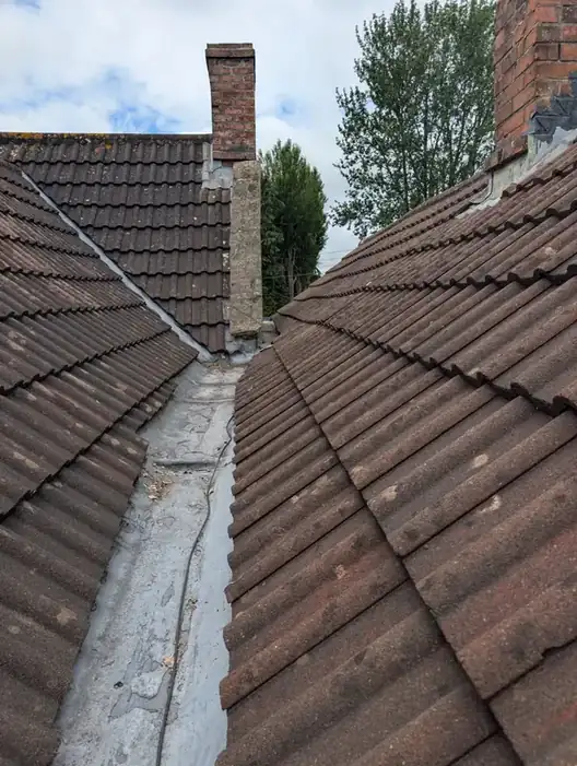Chimney stack with new lead flashing and a lead valley on a tiled roof in Newcastle
