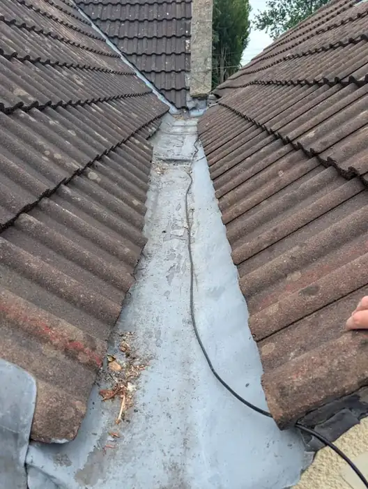Newly fitted lead valley between two tiled roof slopes on a property in Newcastle