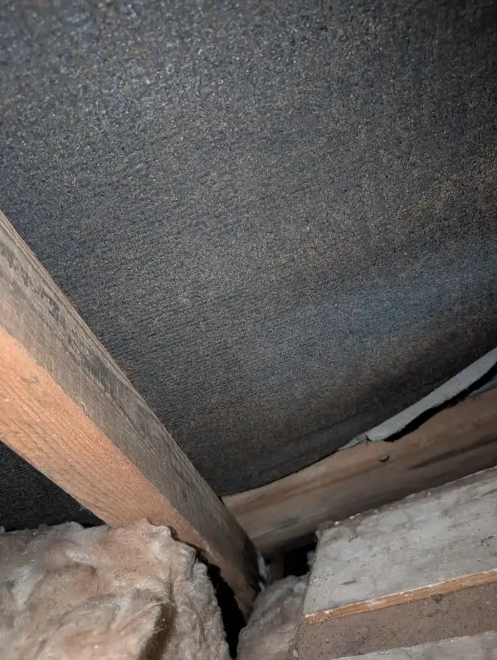 New breathable underfelt laid under roof tiles during a repair
