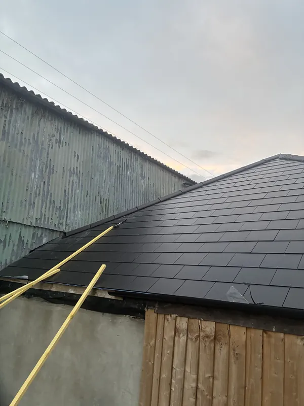 Garage roof re-covered in slate with new timber fencing alongside in Newcastle