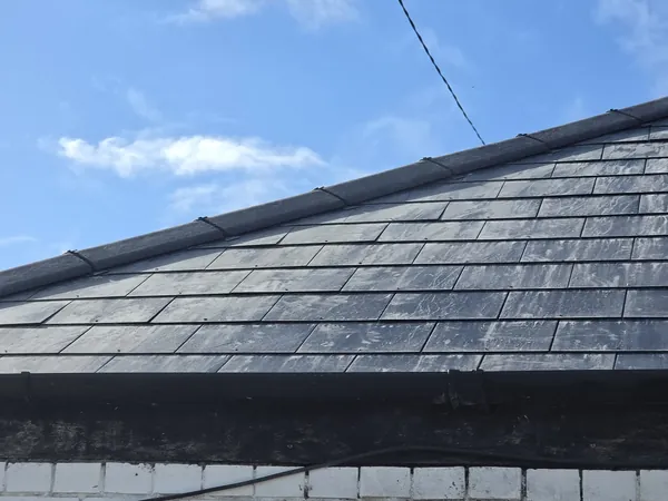 Ridge tiles bedded along the top of a new slate roof in Newcastle